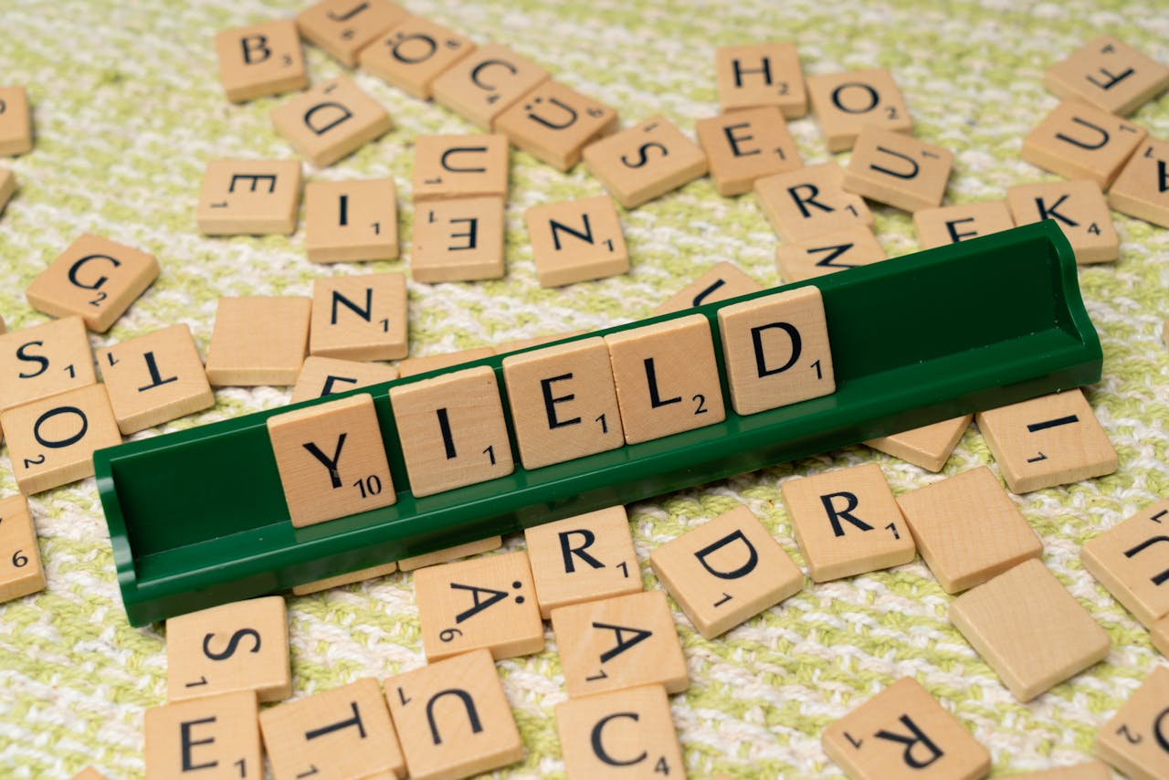 A scrabble board with the word yield written on it